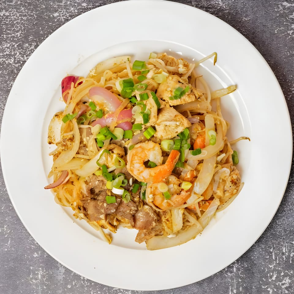 Vo An Vietnamese stir-fried noodles with shrimp, chicken, beef, onions, and green onions.