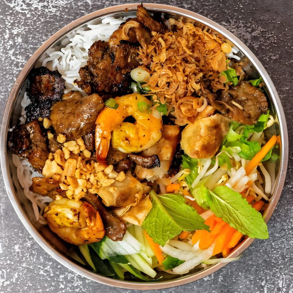 Vo An Vietnamese vermicelli bowl with grilled pork, shrimp, fried onions, and fresh vegetables.